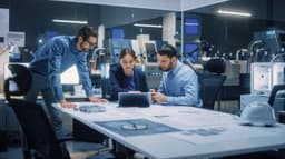 two men and a woman working in an office looking at a tablet device